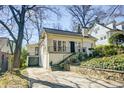 This brick home boasts a convenient driveway, a well-kept lawn, and charming architectural features at 231 Peachtree Ne Way, Atlanta, GA 30305