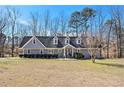 View of a cozy single-Gathering home featuring a well-manicured lawn, neat shrubbery, and a charming entrance at 487 Glendale Ct, Stone Mountain, GA 30087