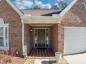 Inviting front entrance showcasing a brick facade and tiled porch at 2701 Garland Way Way, Duluth, GA 30096