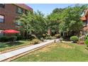 Multi-unit brick building featuring a courtyard lush green landscaping and walking paths at 694 Argonne Ne Ave # 4, Atlanta, GA 30308