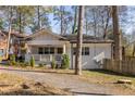 Beautifully renovated home featuring a welcoming front porch and freshly painted white brick exterior at 1598 Olympian Sw Cir, Atlanta, GA 30310