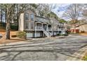 Townhome with a porch, stairs, garages, and a well-maintained landscape at 301 Masons Creek Cir, Atlanta, GA 30350