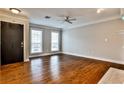 Bright living room with hardwood floors, fireplace, and modern ceiling fan at 301 Masons Creek Cir, Atlanta, GA 30350