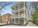 Three-story home with white-columned balconies and a neatly landscaped front yard and driveway at 397 4Th Ne St, Atlanta, GA 30308