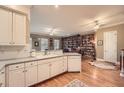 Spacious kitchen featuring white cabinets, hardwood floors and an adjoining library at 397 4Th Ne St, Atlanta, GA 30308