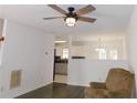 Bright living room featuring hardwood floors, a ceiling fan, and open view to the kitchen at 554 Samaritan Dr, Cumming, GA 30040