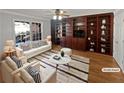 Bright living room featuring a large built-in bookcase, a plush rug, and stylish furniture at 2375 Muirfield Way, Duluth, GA 30096