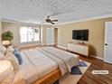 Serene main bedroom boasts a ceiling fan, large window, and sleek furniture at 2375 Muirfield Way, Duluth, GA 30096
