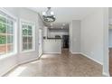 Bright breakfast nook with large windows and a view into the kitchen area at 113 Weatherstone Dr, Woodstock, GA 30188