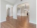 Open-concept living space with hardwood floors and elegant archways at 113 Weatherstone Dr, Woodstock, GA 30188