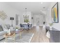 Bright and open living and dining area featuring modern decor and wood-look floors at 170 Chandler Trace, Covington, GA 30016