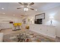 Basement living room with kitchenette, white cabinets, television, ceiling fan, rug, and furniture at 320 Red Fox Dr, Canton, GA 30114