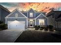 Charming two-story home at twilight features a landscaped yard, attached garage, and welcoming front porch at 147 Treeline Trl, Canton, GA 30115