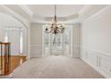 Dining room with large bay window, chandelier, wainscoting and beautiful trim at 3690 Millwater Xing, Dacula, GA 30019