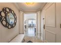 Inviting entryway with a decorative mirror, bench, and views of a city skyline from the interior at 75 14Th Ne St # 3160, Atlanta, GA 30309