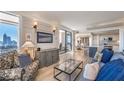 Spacious open concept living area with modern furnishings, a TV, and city views at 75 14Th Ne St # 3160, Atlanta, GA 30309