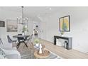 Stylish living room featuring an open floor plan, modern decor, and ample natural light at 150 Chandler Trace, Covington, GA 30016