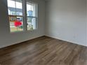 Bright bedroom with hardwood flooring, complemented by natural light from a large window at , Conyers, GA 30094