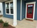 Close up of the red front door with sidelight and white trim, accenting the blue exterior at , Conyers, GA 30094