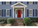 Inviting front entrance featuring a vibrant red door, classic sidelights, and a brick stairway at 4650 Sharon Valley Ct, Atlanta, GA 30360