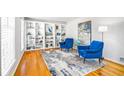 Stylish sitting room featuring built-in bookcases, hardwood floors, and comfortable seating arrangement at 4650 Sharon Valley Ct, Atlanta, GA 30360