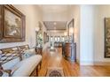 Grand hallway with hardwood floors, decorative furnishings and ample lighting at 4880 Cecilia Sq, Cumming, GA 30040