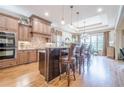 Spacious kitchen featuring stainless steel appliances, a large island, and adjacent dining area at 4880 Cecilia Sq, Cumming, GA 30040