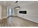Bright dining room featuring modern light fixture, fireplace and vinyl plank floors at 3075 Elizabeth Ln, Snellville, GA 30078