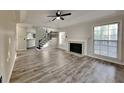 Spacious living room features a fireplace, vinyl plank floors and staircase at 3075 Elizabeth Ln, Snellville, GA 30078