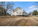 Cozy two-story home featuring shuttered windows, a black door, and a decorative stone wall at 4951 Center Hill Church Rd, Loganville, GA 30052