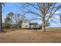 Quaint two-story home featuring shuttered windows, a black door, and rustic tree stump detail at 4951 Center Hill Church Rd, Loganville, GA 30052