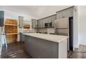 Modern kitchen with gray cabinets, stainless steel appliances, and a center island at 1114 Oak Knoll Se Ter, Atlanta, GA 30315