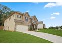 Spacious two-story home with attached garage, lush lawn, and a welcoming driveway at 164 Charolais Dr, Mcdonough, GA 30252