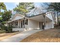 Single-story home with covered parking, brick facade, a porch, and well-maintained landscaping at 2198 Star Mist Sw Dr, Atlanta, GA 30311