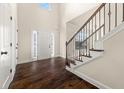 Bright foyer with hardwood floors, staircase, transom window above the front door, and white trim at 3257 Alhambra Cir, Hampton, GA 30228