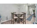 Cozy dining area featuring modern furnishings and wood look floors with an adjacent entryway at 5019 Lower Elm St, Atlanta, GA 30349