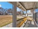 Covered front porch with wood railing overlooking the front yard and street at 10330 Wisteria Ln, Jonesboro, GA 30238