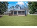 Attractive home with a classic covered porch, offering curb appeal and outdoor living space at 2820 Maxwell Pl, Lithia Springs, GA 30122