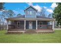 Inviting two-story home featuring a covered front porch with classic railing details at 2820 Maxwell Pl, Lithia Springs, GA 30122