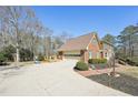 Brick home with a driveway leading to a garage and a small deck at 4805 Mystere Sw Ln, Lilburn, GA 30047