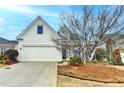 Charming home featuring a two-car garage and inviting curb appeal with a manicured lawn at 1635 Vinery Ave, Cumming, GA 30041