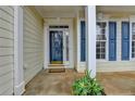 Welcoming front entrance with sidelights and a 'welcome' mat, framed by decorative pillars at 1635 Vinery Ave, Cumming, GA 30041