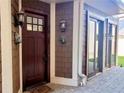 Home entrance featuring a decorative front door, sconces, and brick-paved porch at 322 Gray Shingle Ln, Woodstock, GA 30189