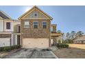 Charming two-story brick home with a two-car garage and a well-manicured lawn, offering a welcoming curb appeal at 3362 Brockenhurst Dr, Buford, GA 30519