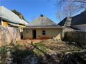 The back exterior of the house reveals a simple design and private backyard, needs renovation at 193 Berean Se Ave, Atlanta, GA 30316