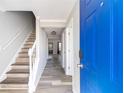 Inviting entryway featuring newly refinished wood floors, fresh paint, and a bright blue front door at 5043 Bell Dr, Smyrna, GA 30080