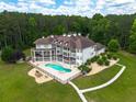 Luxurious home featuring an in-ground pool, hot tub, and large deck for outdoor entertaining at 535 Waters Way, Fayetteville, GA 30215