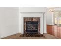 Close up on fireplace with marble surround and white mantle, adding a touch of elegance to the living space at 747 Crestwell Sw Cir, Atlanta, GA 30331