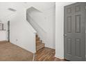 Bright hallway with hardwood flooring and carpeted stairs, leading to the upper level of the home at 747 Crestwell Sw Cir, Atlanta, GA 30331