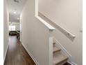 Bright hallway with wooden floors leading to the staircase and open living area at 1310 Speckle Park Way, Stockbridge, GA 30281